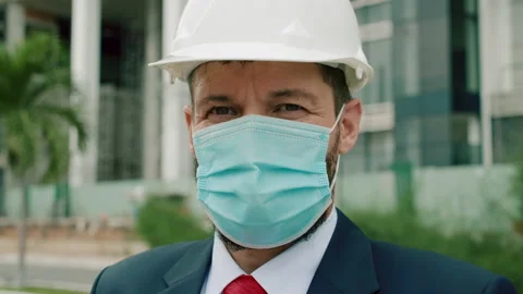 Senior engineer face protective mask in a business suit wearing a white safety Video stock 163367746