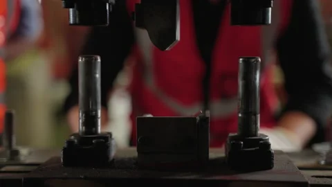 Senior engineer inspects the operation of a metal spare parts machine Stock Footage 175770706