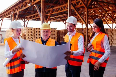 Senior engineer sharing experience with younger co-workers Stock Photos