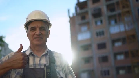 Senior engineer smiling broadly showing thumbs up gesture to camera Stock Footage 91891676