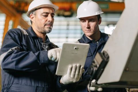 Senior engineer team work with young worker help together check control ope.. Stock Photos