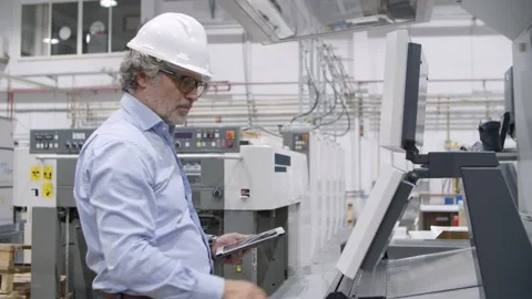 Senior engineer testing industrial machine Stock Footage 147500047