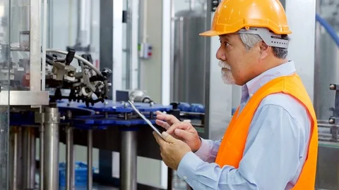 Senior engineer using tablet for work at production line. Stock Footage 91477968