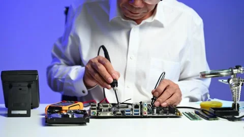 Senior engineer working on computer hardware diagnostics at modern workstat.. Stock Footage 312773635
