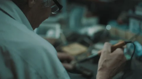 Senior engineer working in garage Stock Footage 66575862