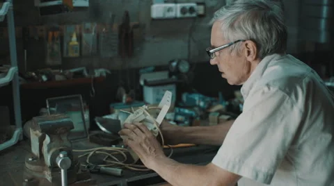 Senior engineer working in garage Video stock 66577021