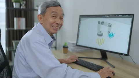Senior engineer working at home. He showing his 3d robot design at home. Stock Footage 211412581