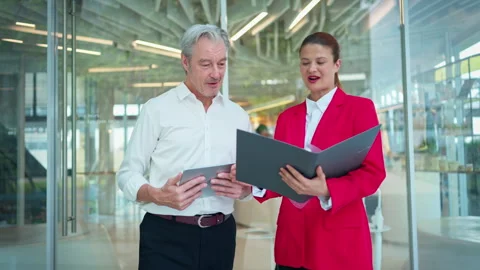 A senior executive and his assistant were using tablets to prepare information Видео 339655033