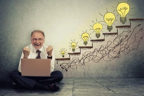 Senior executive man working on computer celebrates success Stock Photos