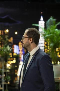 Senior executive standing in side profile with authority and ambition Stock Photos