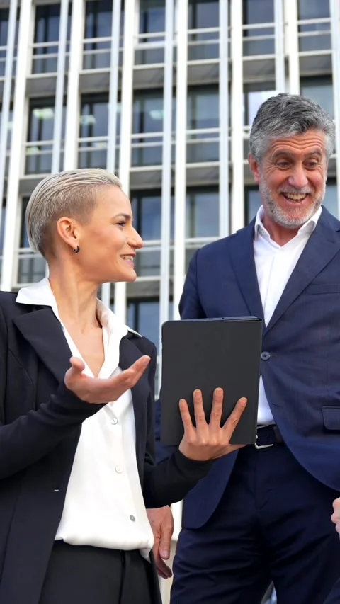 Senior Executives Exchange Ideas with Tablet in Commercial Building Office Vídeos de archivo 259400494