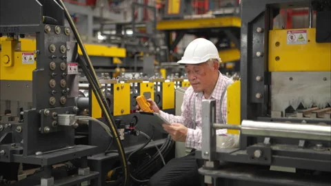 Senior experienced technician checking large machine Stock Footage 317902385