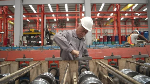 Senior experienced technician checking large machine Stock Footage 317904717