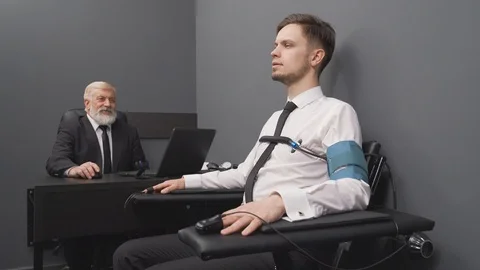 Senior expert checking handsome man with computer polygraph Stock Footage 122628261