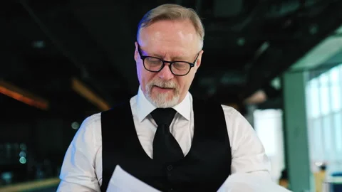 Senior fair-haired bearded man wearing glasses, shirt, tie and vest.  库存影片 276720900