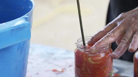 Senior farmer man preparing rustic homemade fresh organic tomato sauce in jar Stock Footage 159237033