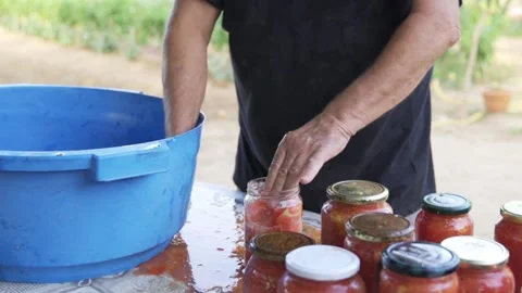 Senior farmer man preparing rustic homemade fresh organic tomato sauce in jar Stock Footage 159237056