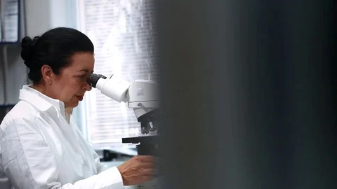 Senior Female Scientist Working on a Microscope at Her Lab Stock-Footage 71778697