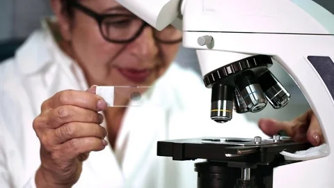 Senior Female Scientist Working on a Microscope at Her Lab Stock-Footage 71779762