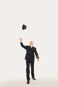 Senior flight captain throwing cap against white background Stock Photos