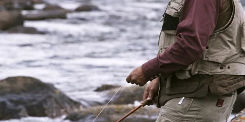 Senior fly fisherman casting into a river in Wyoming Stock Footage 59219145