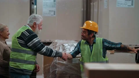 Senior Foreman congratulates warehouse worker on completed work Stock Footage 166709674