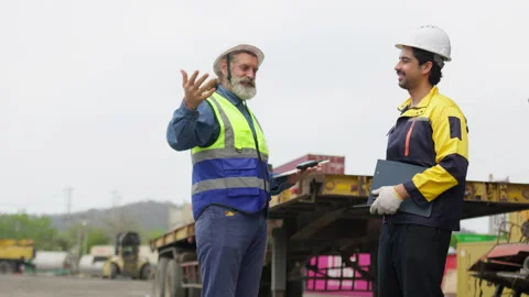 Senior foreman instructs a young engineer on freight management Stock Footage 338295470