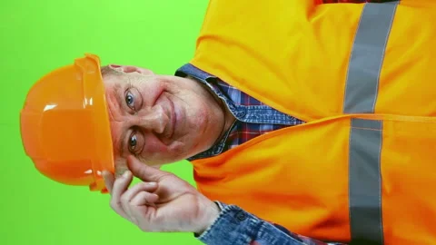 Senior friendly builder in hardhat waves palm for greeting or goodbye sign. Stock Footage 252294179