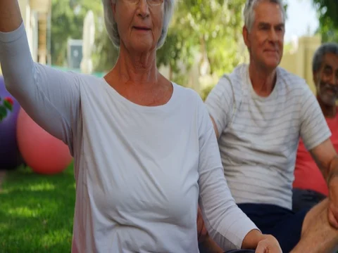 Senior friends doing exercise in garden 4k Stock Footage 80048723