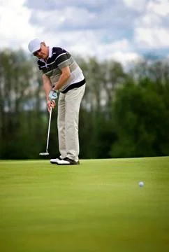Senior golf player putting. Stock Photos