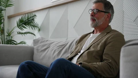 Senior gray haired bearded man drinks water from a glass Stock Footage 278986996