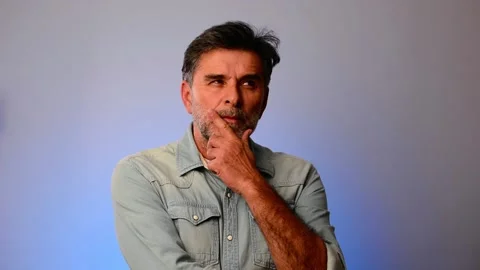 Senior grey bearded man thinking and looking, isolated on blue background. Stock Footage 148236640