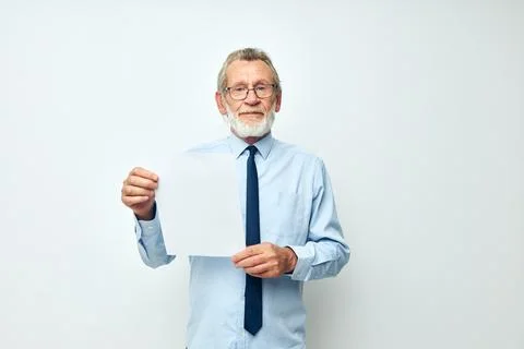Senior grey-haired man in a shirt with a tie copy-space sheet of paper isolated Stock Photos