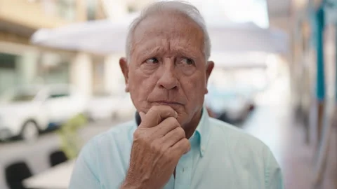 Senior grey-haired man standing with doubt expression at street Stock Footage 206514235