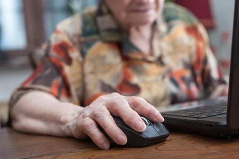 Senior hand using the mouse of a computer Stock Photos