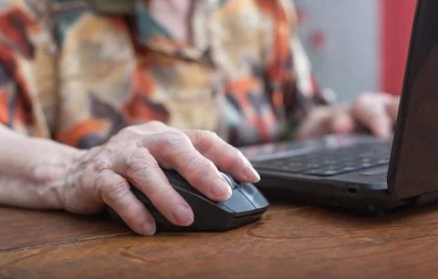 Senior hand using the mouse of a computer Stock Photos