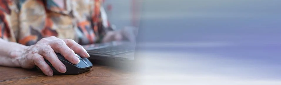 Senior hand using the mouse of a computer; panoramic banner Stock Photos