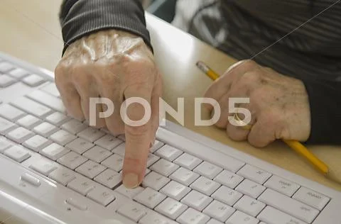 Senior hands on keyboard Stock Photos