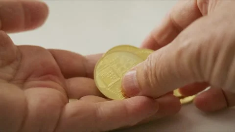 Senior Hands Sorting Physical Crypto Tokens on Neutral Tabletop Stock Footage 346380394