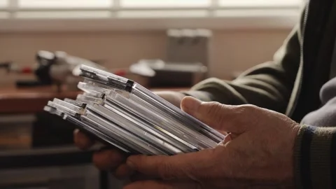 Senior hands sorting a stack of CD cases Stock Footage 312166786