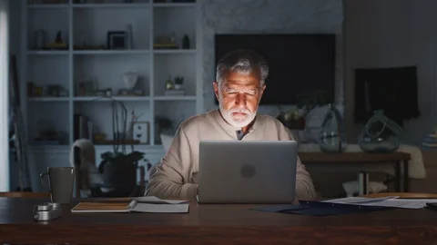 Senior Hispanic man checking his finances online at home using a laptop computer Stock Footage 106685231