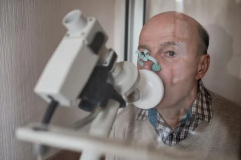 Senior hispanic man man testing breathing function by spirometry Stock Photos