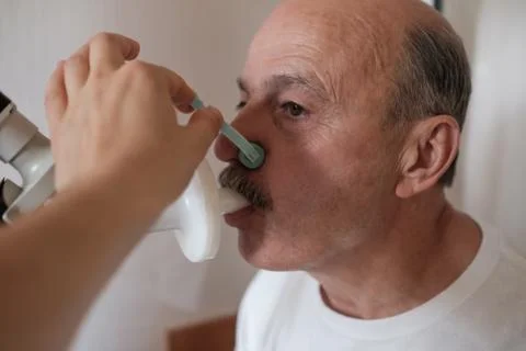Senior hispanic man man testing breathing function by spirometry Stock Photos
