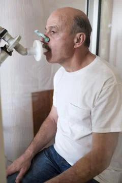 Senior hispanic man man testing breathing function by spirometry Stock Photos