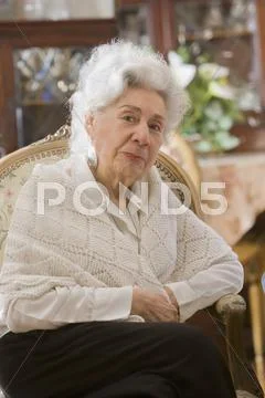 Senior hispanic woman sitting in chair Stock Photos