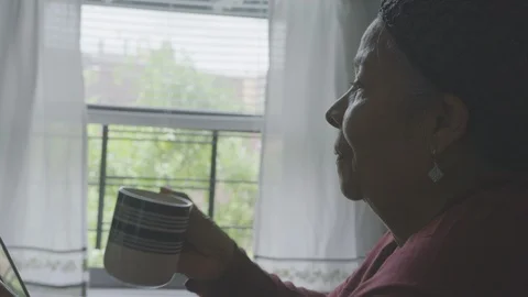 Senior Hispanic Woman Using Sips Coffee with Phone in Morning Stock Footage 94418599