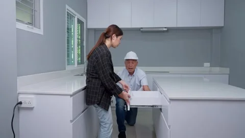 Senior home inspector checking home defects and teaching young engineers, b.. Stock Footage 260319232