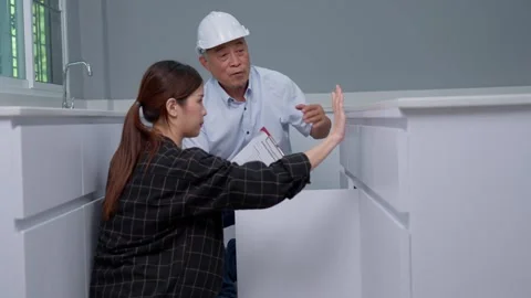 Senior home inspector checking home defects and teaching young engineers, b.. Stock Footage 262971815