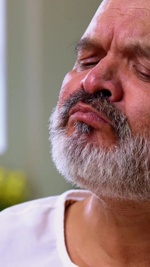 Senior Indian man sitting with snacks, reacting joyfully to tasty Stock-Footage 343107192