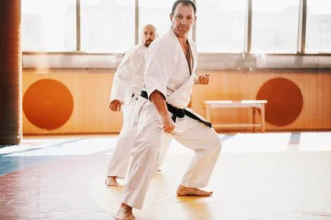 Senior karate master looks though on tatami Stock Photos
